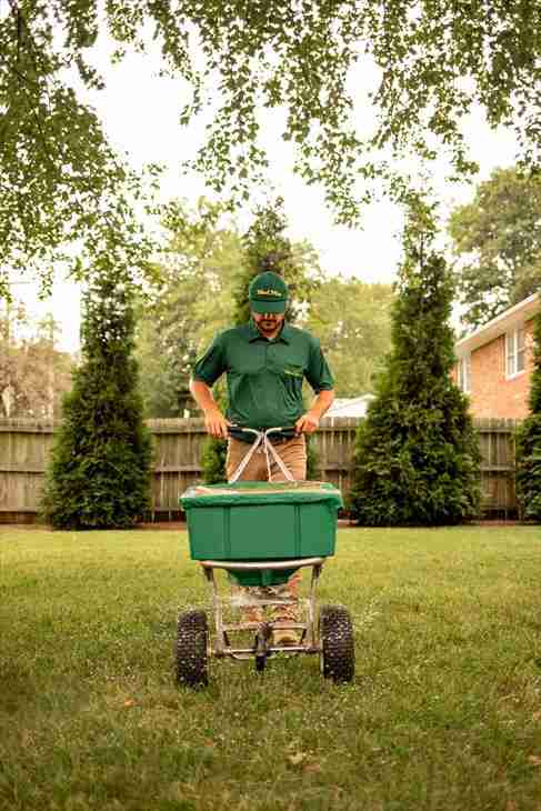 Weed Man Technician Fertilizing Lawn